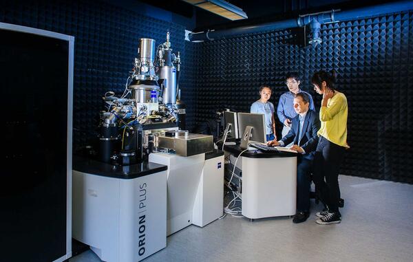 students and professor in the lab